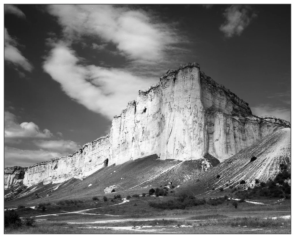 A luminous mountain rising beneath dramatic clouds